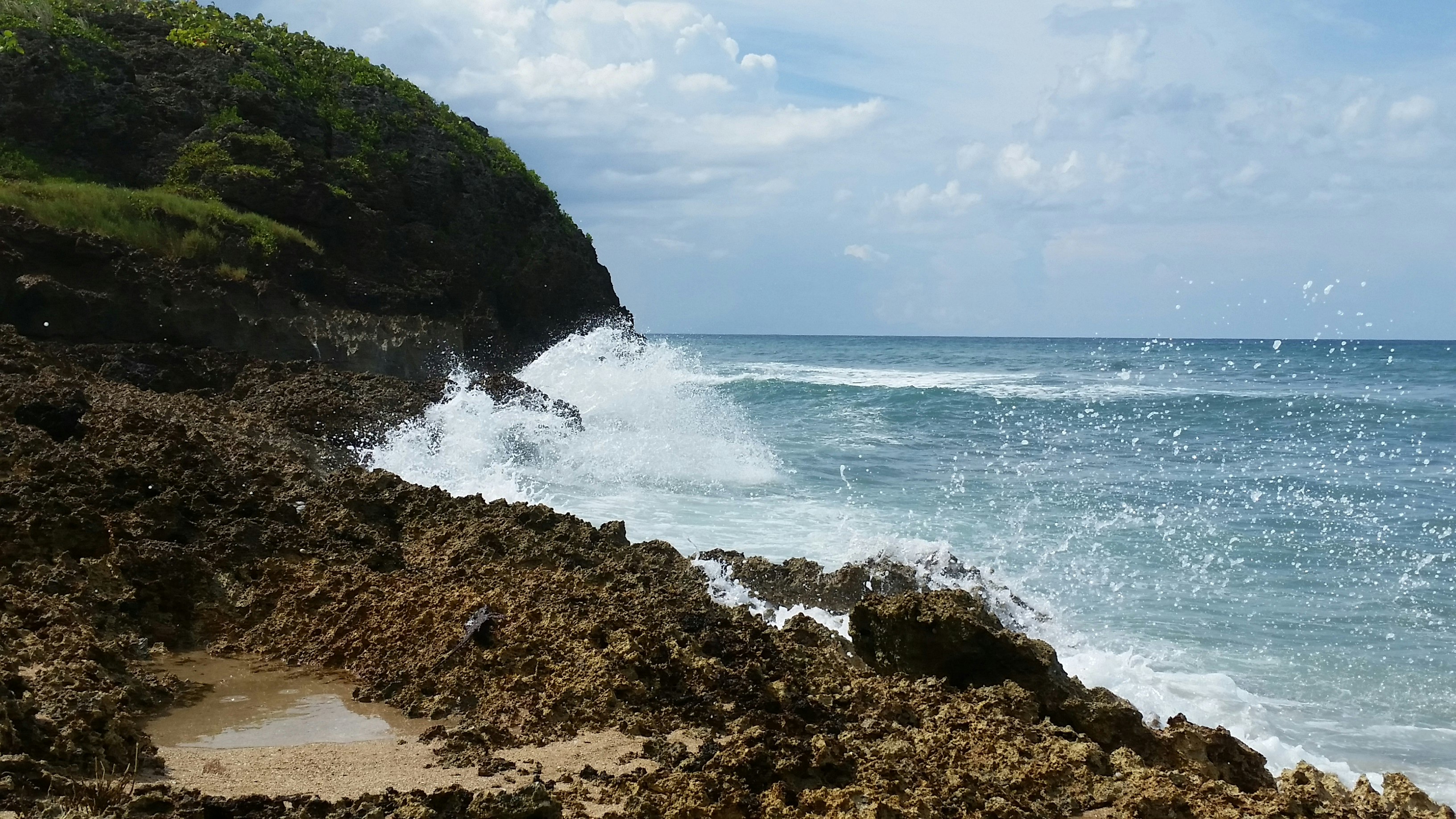 sea waves crashing through rock shore